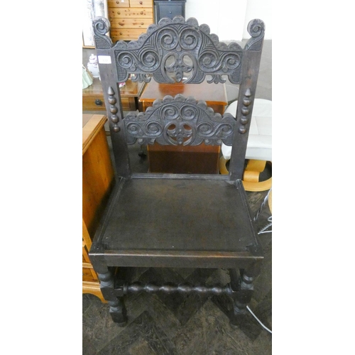 172 - A Victorian carved dark oak hall chair with panel seat