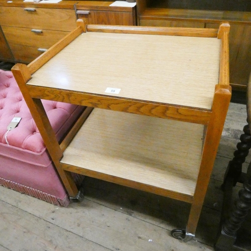 44 - A two tier oak tea trolley with Formica shelves