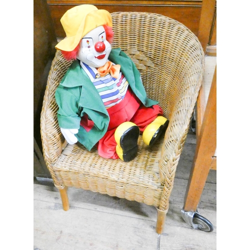 43 - A child's wicker chair with clown doll