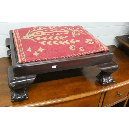 52 - A reproduction mahogany framed footstool on claw and ball feet with upholstered top