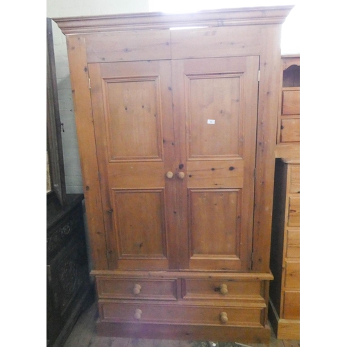 64 - A pine two door wardrobe with three drawers under, 3'9 wide