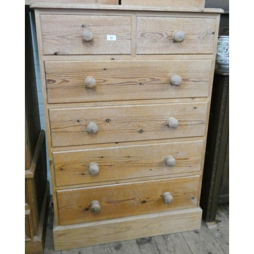 65 - A stripped pine tallboy chest of four long and two short drawers with bun handles, 2'9 wide