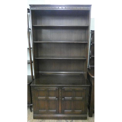 73 - An Ercol oak dresser with shelf back and cupboards under, 3'3 wide