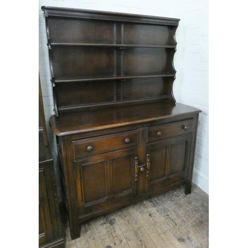 74 - An Ercol oak dresser with shelf back, drawers and cupboards under, 4' wide