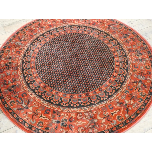 96 - A circular red and patterned wool pile rug