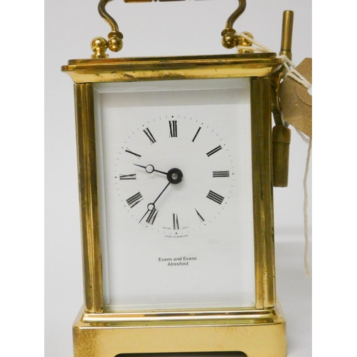 505 - A brass and glass cased carriage clock with key