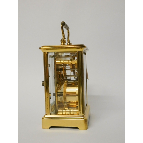 505 - A brass and glass cased carriage clock with key