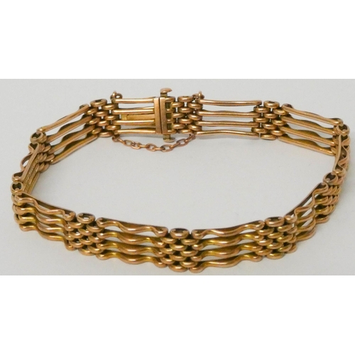 610 - A 9ct rose gold gate bracelet with concealed box fastening and safety chain. 14.2 grams