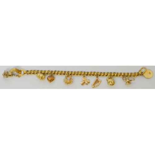 619 - A charm bracelet - unmarked yellow metal bracelet - tests as 9ct gold, set with numerous hallmarked ... 