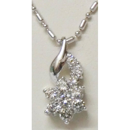 651 - An 18ct white gold modern diamond cluster pendant on 18ct white gold chain. Matches preceding lot