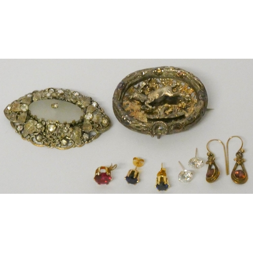 672 - A vintage oval brooch decorated with a deer, another and a collection of gold pierced earrings, set ... 