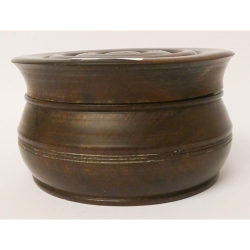 555 - A Lignum Vitae circular box with lid, 6