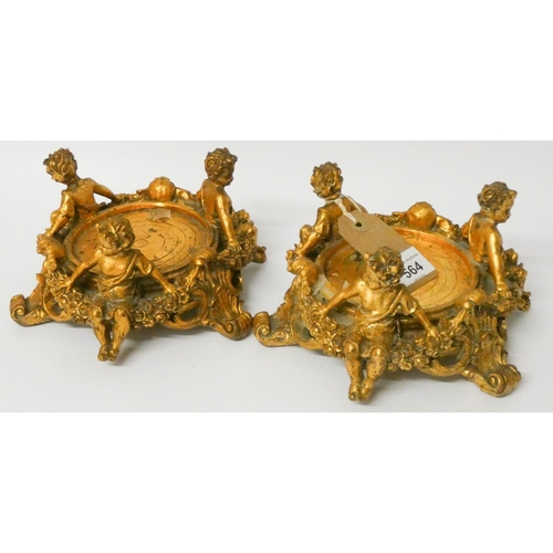 564 - A pair of gilt cherub mounted bottle stands