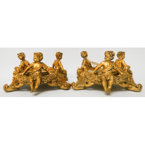 564 - A pair of gilt cherub mounted bottle stands