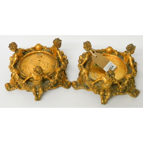 564 - A pair of gilt cherub mounted bottle stands