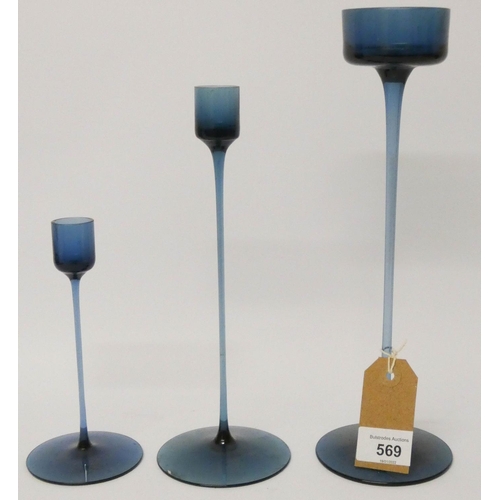 569 - A set of three Wedgwood blue glass graduated fine candlesticks with original boxes, tallest 11