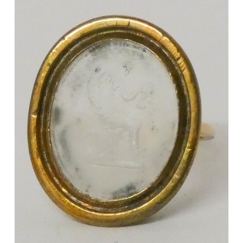 597 - Antique intaglio ring set with an oval carved rock crystal panel, size N