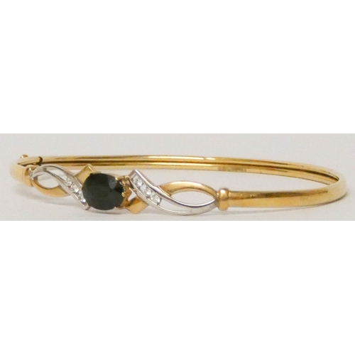 598 - 9ct yellow gold modern sapphire and diamond set bangle. 4.1 grams