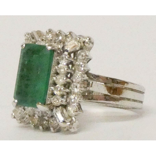 648 - 18ct white gold emerald and diamond rectangular cluster ring, in a raised three tier setting, ring s... 