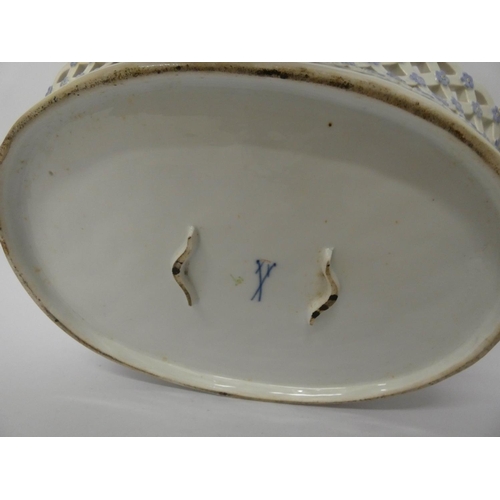 896 - An oval pierced and floral decorated porcelain fruit bowl with Meissen cross swords mark to the base... 