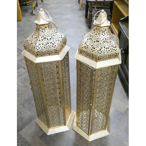 112 - A pair of gold coloured pierced metal Moroccan style hanging lanterns