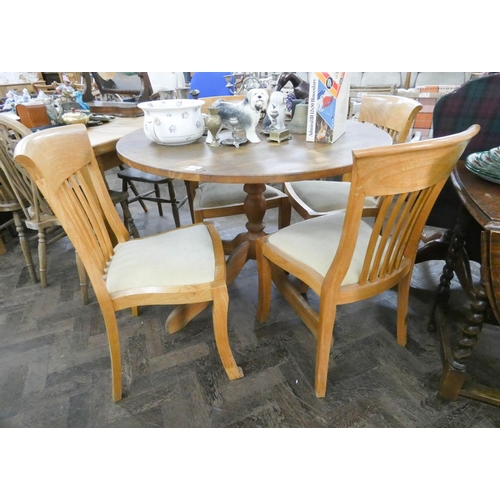 130 - A circular pine single pillar dining table and four light oak slat back dining room chairs with crea... 