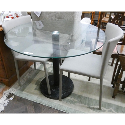 181 - A circular glass single pillar bistro style table and a pair of matching fawn chairs