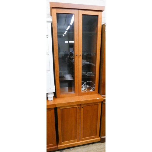 39 - A cherry wood finished sideboard fitted cupboards and centre drawers and a matching glazed bookcase ... 