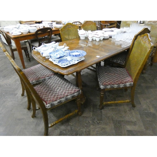 63 - A walnut finished extending dining table with two centre leaves, together with six matching standard... 