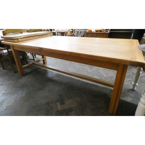 9 - A large modern heavy light oak dining table with two centre leaves, standing on heavy refectory styl... 