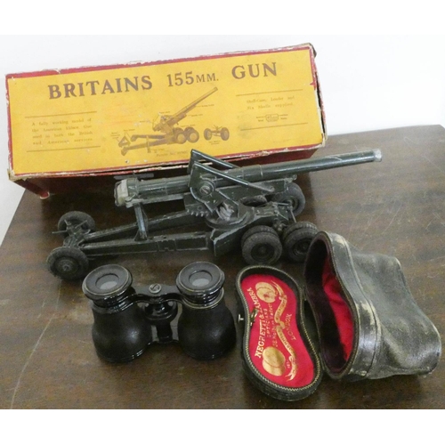 94 - A Britain's scale model of a 155mm field gun and a pair of opera glasses in case