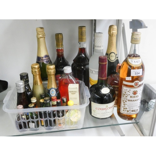 334 - Two bottles of sparkling wine, bottle of Keo brandy, bottle of Courvoisier, two bottles of cherry br... 