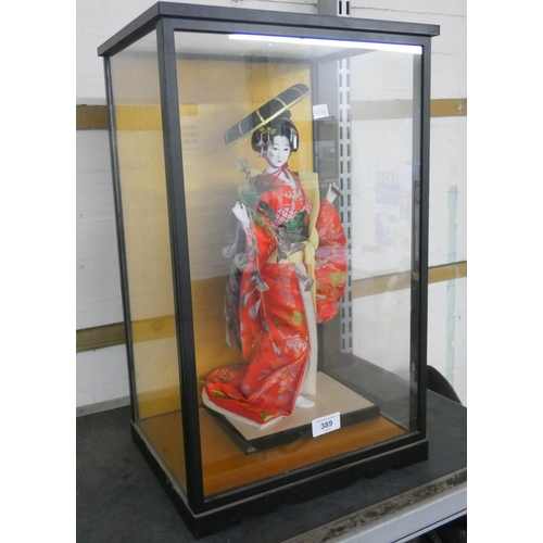 389 - A oriental Geisha girl in glass cabinet