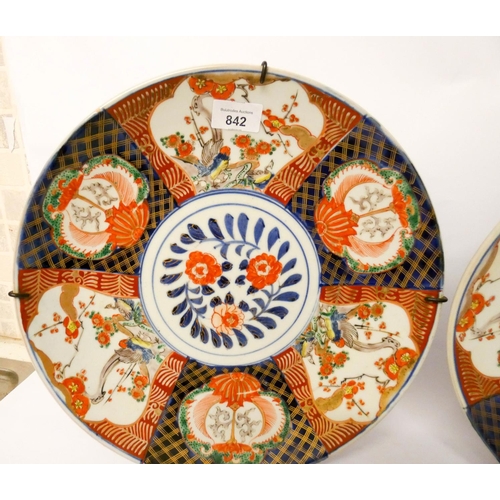 514 - Pair of decorative Japanese Imari wall plates, each measuring 34cm across