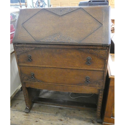 110 - An oak bureau with two long drawers under, 2'6 wide