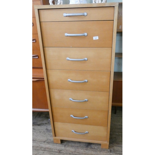 122 - A tall light oak finished chest of seven drawers, 2' wide