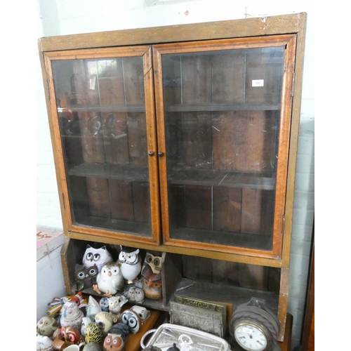 129 - A glazed wooden two door cabinet, 43