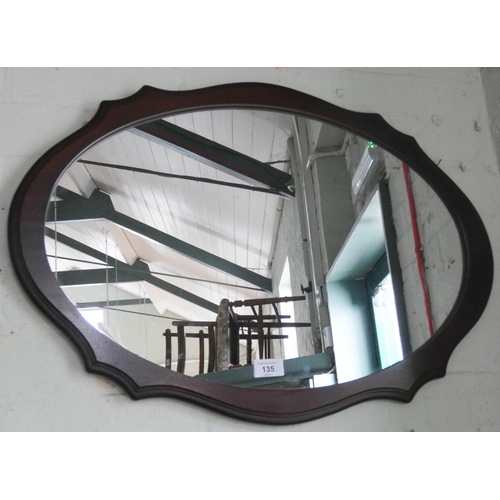 135 - An oval wall mirror in shaped wooden frame