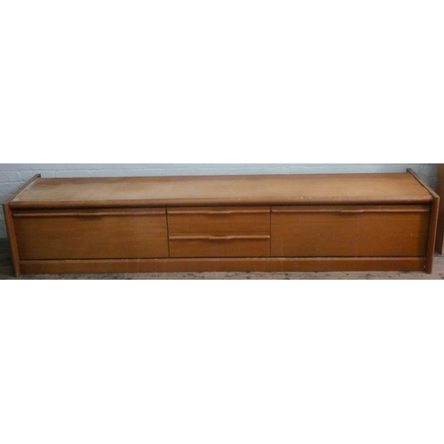 28 - A mid-century teak media unit, fitted drawers and pull down flaps, as found condition, 8' long and 1... 