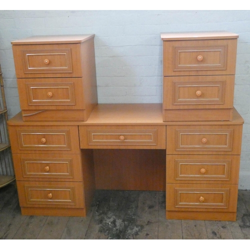 50 - A modern light teak finished knee hole dressing table, fitted seven drawers, 63