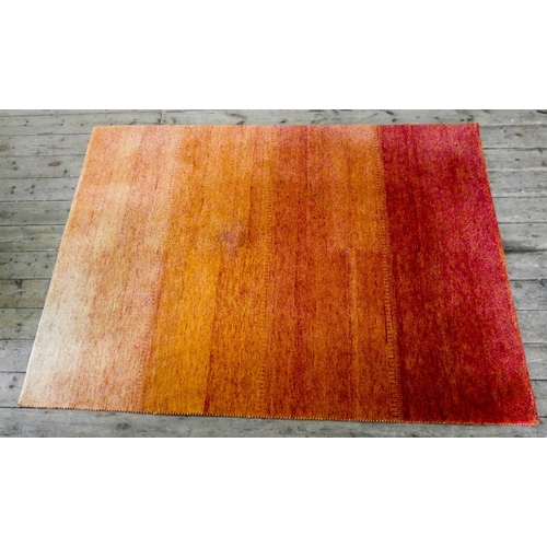 65 - A large orange wool pile rug