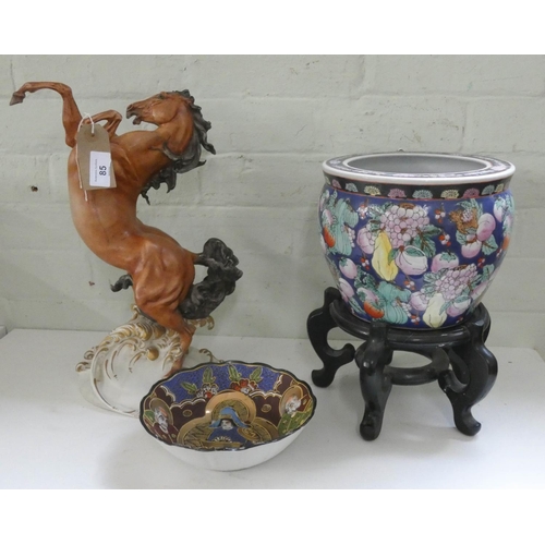 85 - Capodimonte rearing horse ornament, oriental jardinière with wooden stand and another Japanese bowl