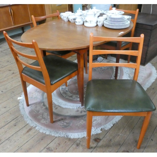 90 - A 1970's Schreiber oval teak dining table and four matching ladder back style chairs