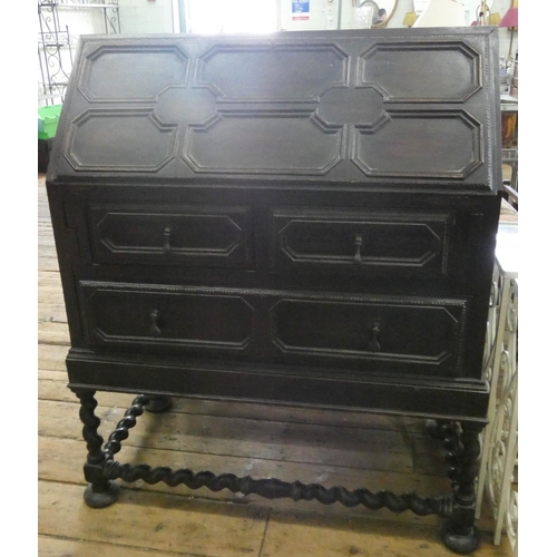 99 - A Jacobean style oak bureau with drawers under standing on barley twist legs with cross stretchers, ... 