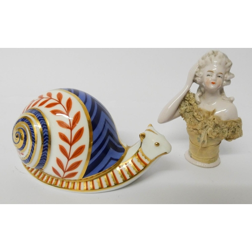 511 - A Royal Crown Derby paper weight of a snail and a pin cushion half doll