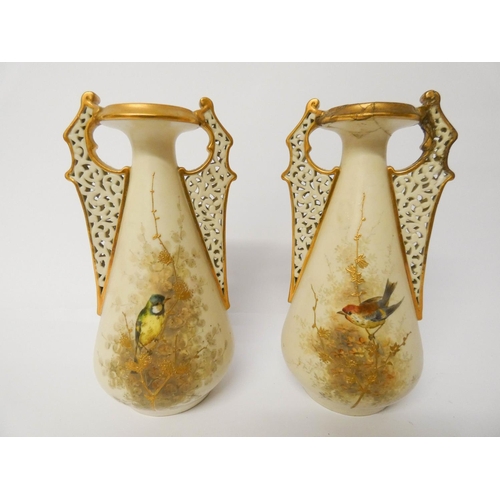 512 - A pair of Royal Worcester China Works twin handled vases painted with British birds, 19cm tall