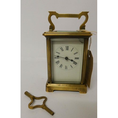 543 - A gilt brass carriage clock and key