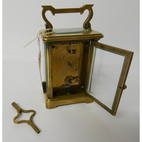 543 - A gilt brass carriage clock and key