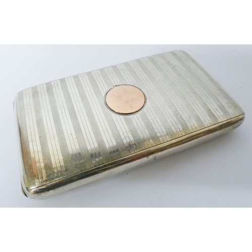 610 - A hallmarked silver engine turned double cigarette box with inset gold panel to the lid, gross weigh... 