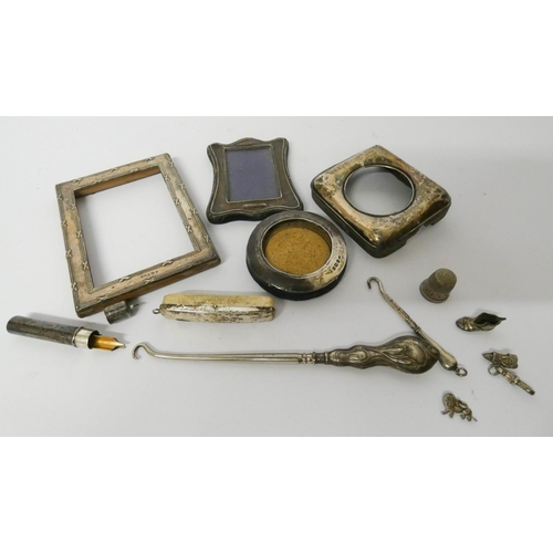 613 - A collection of small silver ware to include miniature photograph frames, silver handled button hook... 